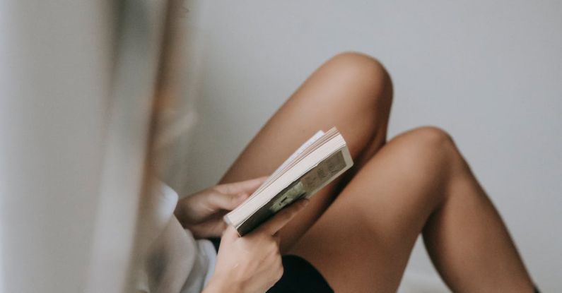 Short Story - Crop unrecognizable woman reading book on cozy bed