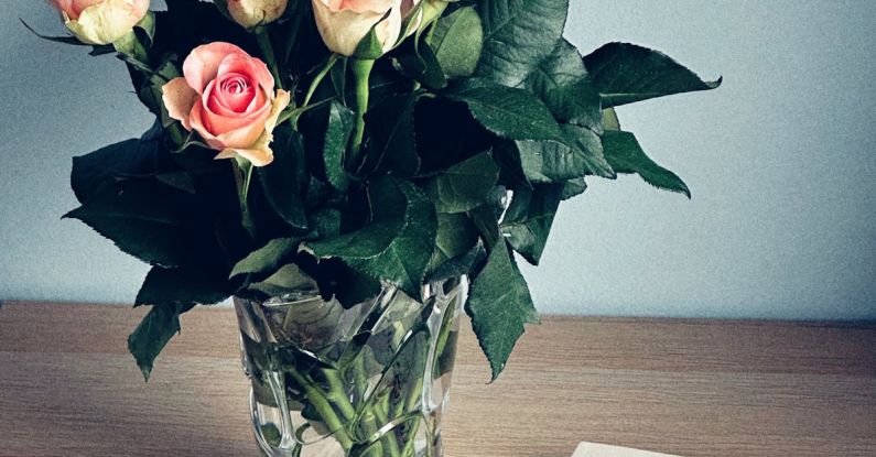 Modernist Literature - A book and a vase of pink roses