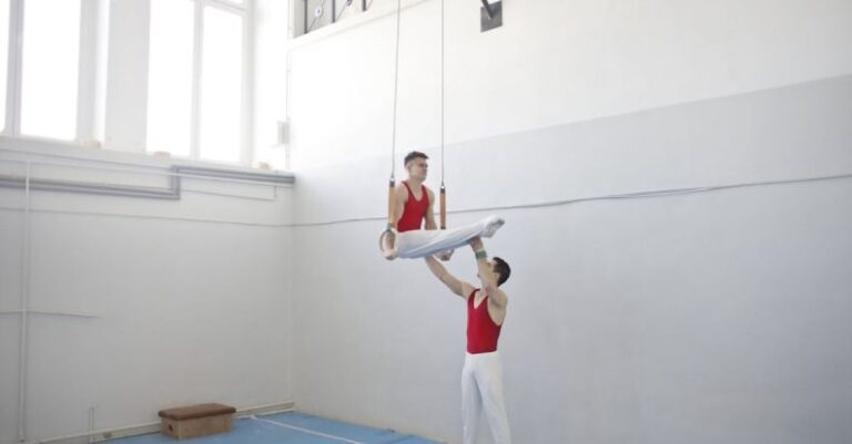 Training - Men in White Pants Red Jersey Near Wall