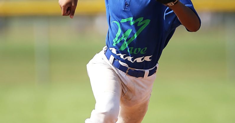 Youth Sports - Boy in Blue and White Baseball Jersey Running on Brown Soil Field during Daytime
