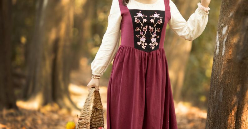 Folk Tales - Portrait of a Woman in a Rustic Dress with a Basket in a Forest