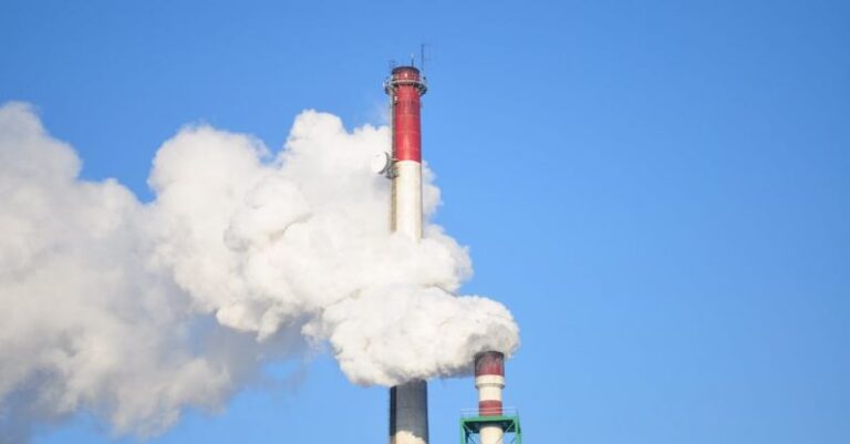 Global Warming - Smoke Stacks Against Blue Sky